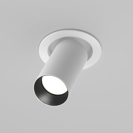 The Artisan Single Tilt Round Recessed Downlight in white is mounted in a gray ceiling. With its tilt mechanism, it casts a focused beam downward. Its sleek, modern design is complemented by durable aluminum construction.