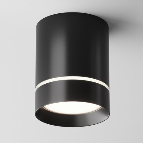 The Orlo LED Round Surface Downlight 9W 4000K in black features a sleek cylindrical design with an energy-efficient LED downlight. It has a narrow illuminated band at the top and a broader light source at the base, set against a plain white background.