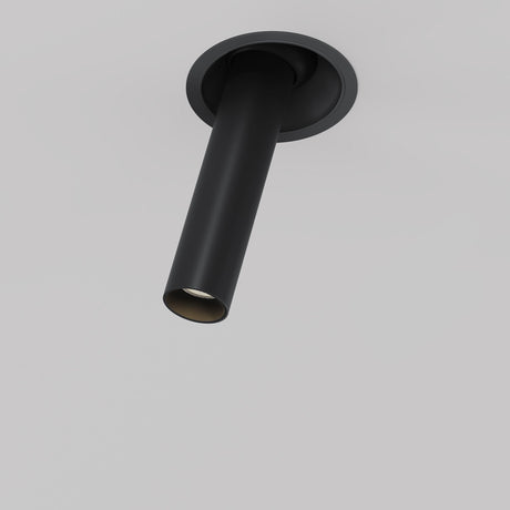 The Focus T LED Adjustable Short Retractable In-Out Recessed Downlight 7W 3000K in black is a contemporary cylindrical ceiling fixture with a sleek design, offering directional lighting from a circular mount on a white ceiling, and features an energy-efficient adjustable LED.