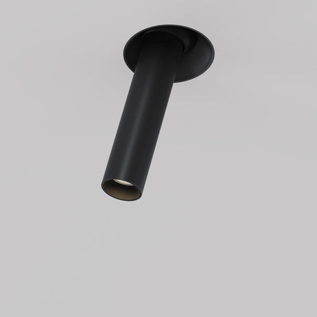 The Focus T LED Adjustable Short Trimless Retractable In-Out Recessed Downlight 7W 3000K in black features a sleek, cylindrical design with an energy-efficient matte finish, angled slightly downward against a light gray background.