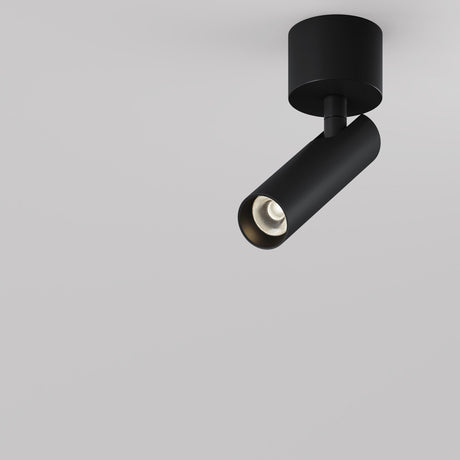 Against a plain white background, the Focus T LED Short Single Spotlight 6W 3000K - Black is mounted, showcasing its minimalist black cylindrical design and offering energy-efficient illumination with its LED spotlight.