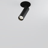 The Focus T LED Adjustable Short Recessed Downlight 6W 3000K in black is a sleek, cylindrical ceiling fixture on a white surface. It offers an LED downlight angled slightly downward, ideal for energy-efficient spotlighting in modern interiors with its minimalist design.