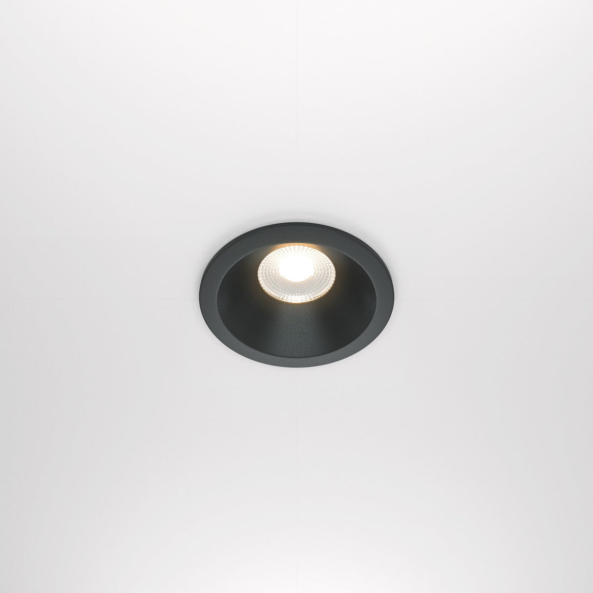The Zoom LED Dimmable Round Recessed Downlight 12W 3000K - Black softly illuminates with a warm glow and features a black rim against a white background.