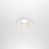 The Zoom LED Dimmable Round Recessed Downlight 12W 3000K in white casts a bright, circular glow on the ceiling, offering soft, even illumination.