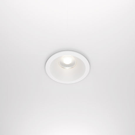 The Zoom LED Round Recessed Downlight 12W 4000K in white features a ceiling-mounted, minimalist design with a white circular frame and glowing center bulb. It has CRI 90, IP65 rating, offering sleek modern aesthetics against a white ceiling.