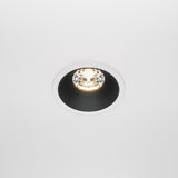 The Alfa LED Fixed Round Recessed Downlight 15W 3000K - White & Black is installed in a white ceiling, offering a modern design with its sleek black inner ring and white outer rim. When on, it casts a bright, warm glow, serving as an ideal contemporary lighting fixture for any space.