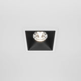 The Alfa LED Fixed Square Recessed Downlight 15W with a white frame and black trim emits a bright 4000K cool white light, illuminating the plain white ceiling.