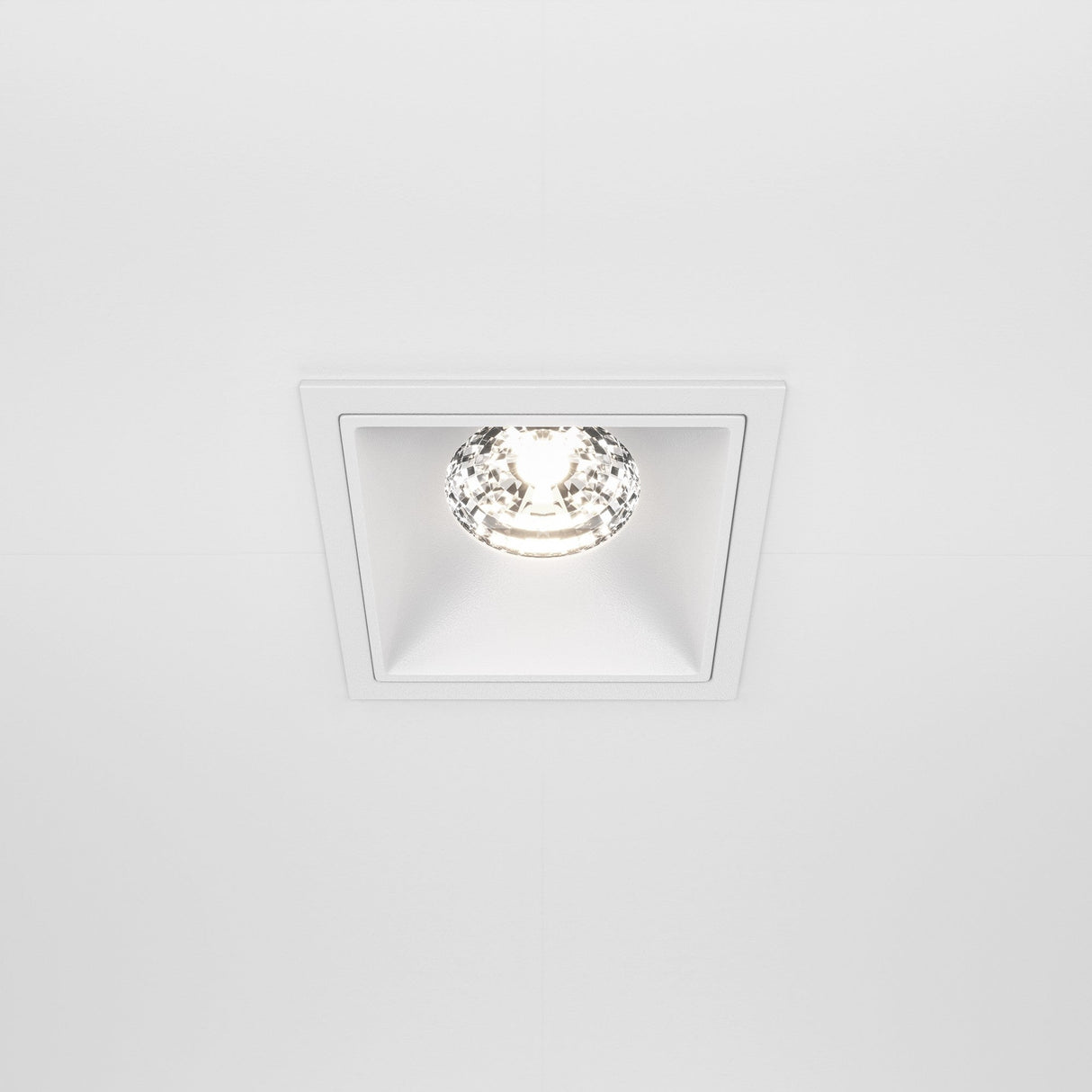 The Alfa LED Fixed Square Recessed Downlight 15W 4000K - White features a minimalistic design with a bright, circular LED bulb, blending seamlessly into modern interiors and spreading cool white light evenly across the ceiling.