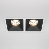 The Alfa LED Twin Fixed Square Recessed Downlight 30W 3000K - White & Black adds modern flair with two black-walled compartments with glowing bulbs. Set in a white ceiling, it casts warm illumination that enhances any space.