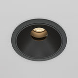 The Wise LED Round Recessed Downlight 10W 3000K - Black showcases a minimalist design with its black circular frame on a white surface, emitting a warm glow that creates an inviting atmosphere, enhanced by its high Colour Rendering Index (CRI).