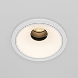 The Wise LED Round Recessed Downlight 10W 3000K features a minimalist white trim with a warm LED bulb, partially visible inside a textured interior, against a smooth light-colored ceiling surface.