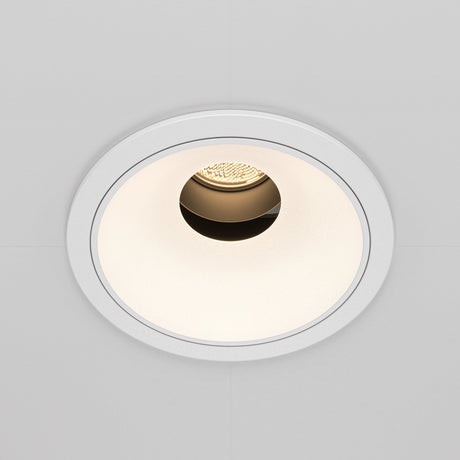 The Wise LED Round Recessed Downlight 10W 3000K features a minimalist white trim with a warm LED bulb, partially visible inside a textured interior, against a smooth light-colored ceiling surface.