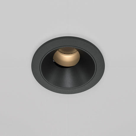 The Wise LED Round Recessed Downlight 7W 3000K in black features a sleek, black circular frame with a gold inner surface, housing an LED spotlight that complements the white ceiling.