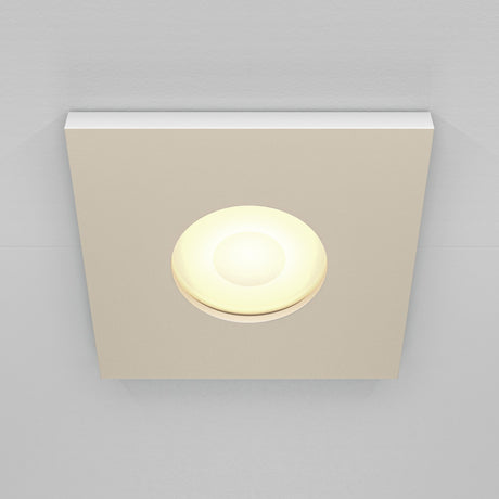 The Stark Fixed Square Recessed Downlight - White features a glowing circular bulb and GU10 bulbs, set against a light gray ceiling.
