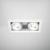 A close-up of the Metal Modern LED Rectangular Recessed Twin Downlight 20W 3000K - White, featuring a dual circular bulb design. The seamless rectangular fit enhances efficiency while emitting a soft yellowish light.