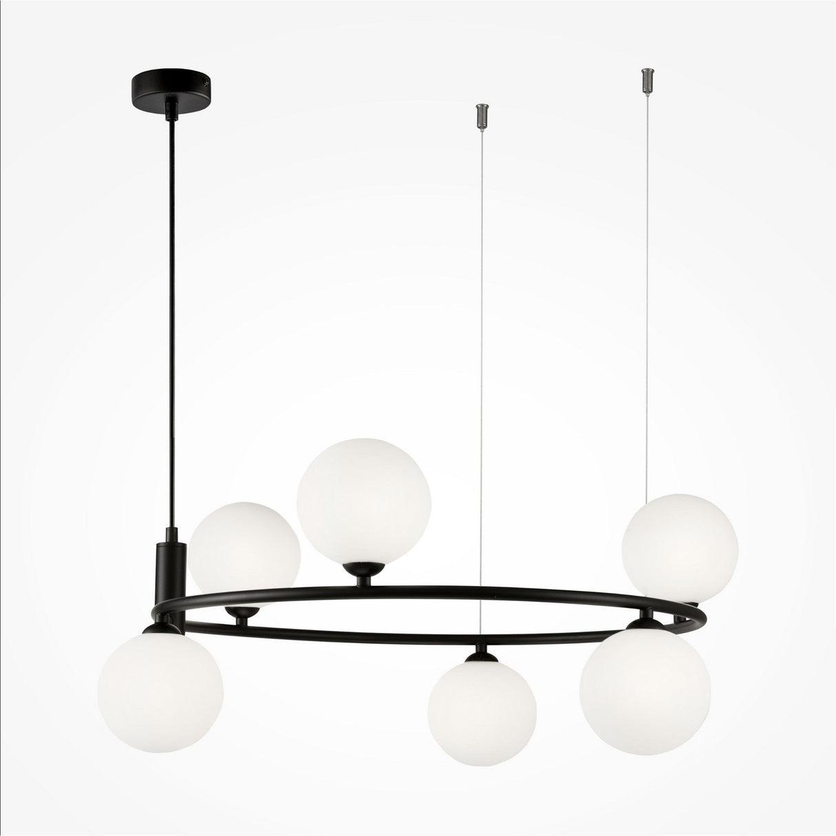 The Ring 6 Light Circular Suspension features a sleek black metal frame with six frosted white glass globes suspended at different heights by thin wires. The fixture is ceiling-mounted with a central rod and offers adjustable height for versatile elegance.