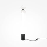 The Kyoto LED Floor Lamp - Black has a minimalist design with a slim black stand, sleek marble base, and double-cone white lampshade for energy-efficient lighting, complemented by a black power cord against a plain light background.