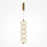 The Golden Cage LED Pendant Light - Gold With Wire Spheres features a modern gold finish with stacked wire spheres, suspended by a cable from a cylindrical ceiling mount. It incorporates energy-efficient LED technology for an elegant and sustainable lighting solution.