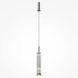 The Ordo LED Short Pendant Light, featuring a sleek chrome finish and a vertically ridged clear cylindrical glass shade, elegantly hangs from the ceiling. A thin wire suspends it from a round ceiling mount, showcasing its modern design.