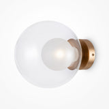 The Basic Form Big Clear Ball Wall Light - Gold features an opal glass globe with a frosted bulb. Its sleek, modern design pairs a gold metal base against a white background, bringing sophistication and elegance to any space.