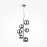 The Dallas 6 Light Drop Suspension features a sleek metal rod suspending six smoked mirrored glass spheres, exuding minimalist and contemporary elegance with its asymmetrical cluster design.