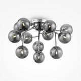 The Dallas 12 Light Semi-Flush features a modern chrome base with a cluster of spherical smoky glass bulbs, each showcasing a visible filament for an elegant contemporary design.