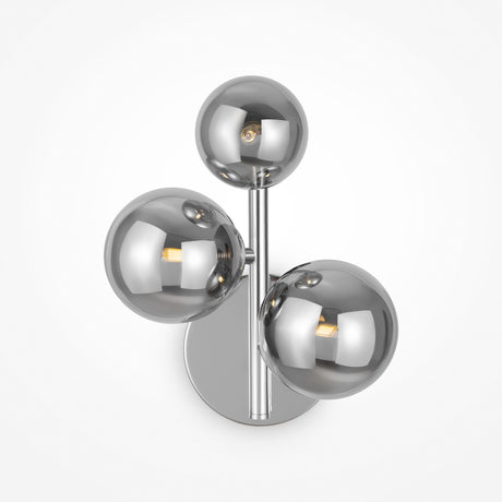 The Dallas 3 Light Wall Light boasts a chic design with three reflective spherical bulbs made from smoked mirrored glass, mounted on a chrome stem with a circular base, embodying modern decor.