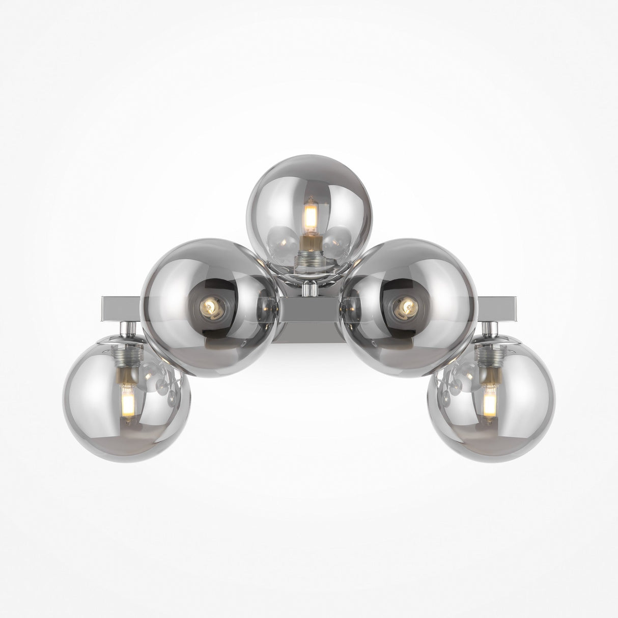 The Dallas 5 Light Wall Light in chrome showcases five spherical bulbs arranged in a triangular design. With clear bulbs revealing glowing filaments, its sleek metallic base is complemented by an elegant smoked mirrored glass finish.