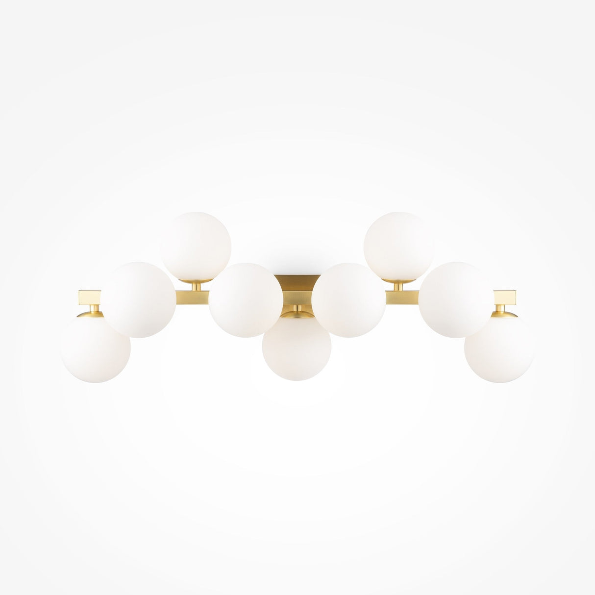 The Dallas 9 Light Wall Light features a sleek brass frame with nine evenly spaced white opal glass globes, creating a symmetrical design ideal for ambient lighting against a white backdrop.