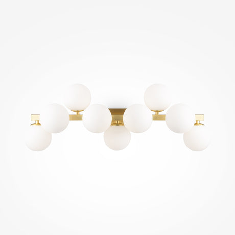 The Dallas 9 Light Wall Light features a sleek brass frame with nine evenly spaced white opal glass globes, creating a symmetrical design ideal for ambient lighting against a white backdrop.