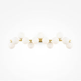 The Dallas 13 Light Wall Light - Brass With White Glass features a minimalist design with a brass horizontal bar and sixteen round white opal glass bulbs arranged in two rows, enhancing any space with its elegant brass fittings.