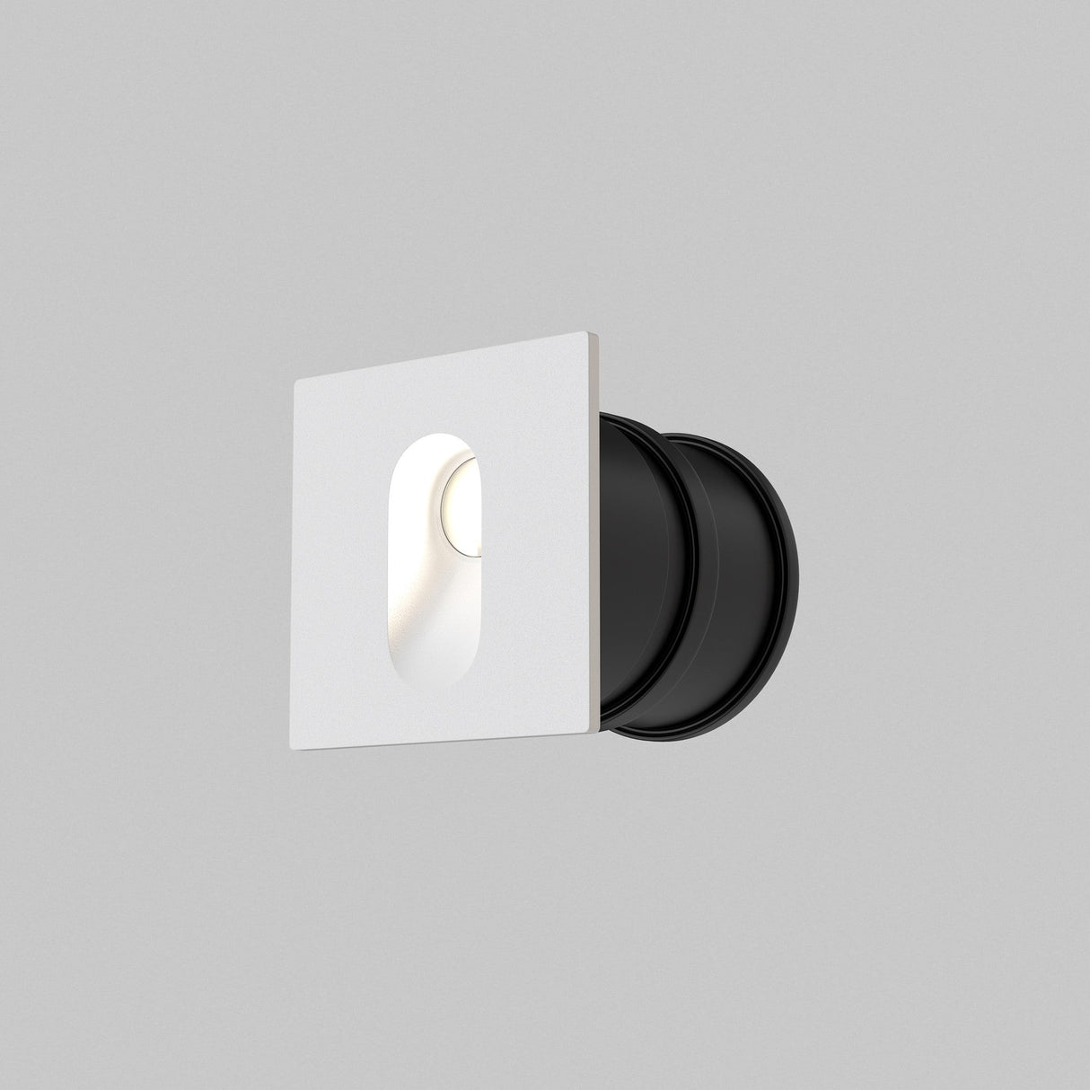 The Via Urbana Outdoor LED Recessed Wall Light 4000K 3W - White features a minimalist white square design with a rounded black base. Its an IP54 rated fixture that offers a modern and sleek appearance against a plain gray background.
