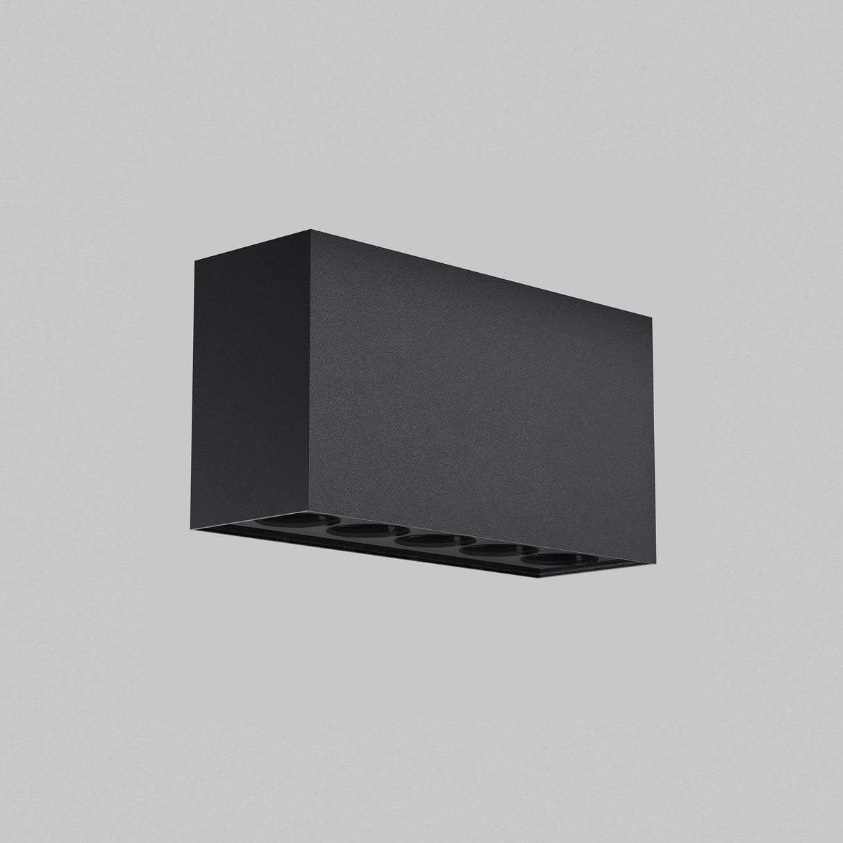 The Ares Outdoor LED Rectangular Downlight in Graphite is mounted on a light gray wall, showcasing a sleek, minimalist design. Its multiple round light openings beneath are ideal for terrace lighting.