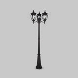 The Fleur 3 Light Triple Head Lamp Post - Bronze Antique is a vintage-style street lamp in black, featuring three ornate lanterns with clear glass panes. It stands on a square base with an antique bronze finish against a plain gray background.