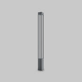 The Elbe Bollard Light 150cm in Graphite is a sleek, modern floor lamp with a tall rectangular shape. Featuring two vertical slits for soft white illumination, its contemporary metallic finish adds elegance to any setting, gracefully enhancing a plain white backdrop.