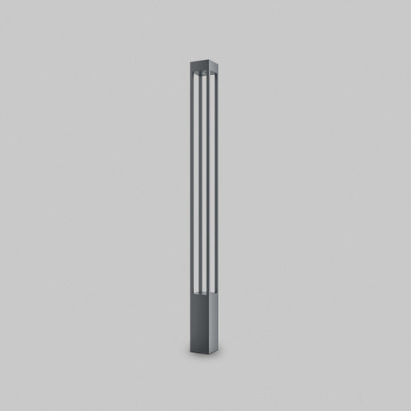 The Elbe Bollard Light 150cm in Graphite is a sleek, modern floor lamp with a tall rectangular shape. Featuring two vertical slits for soft white illumination, its contemporary metallic finish adds elegance to any setting, gracefully enhancing a plain white backdrop.
