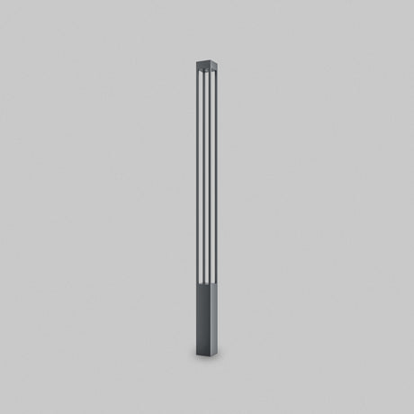 A tall, slender floor lamp with a minimalist graphite design stands against a white background, featuring four vertical light strips resembling the Elbe Bollard Light 200cm - Graphite. Its dark rectangular base creates a modern and elegant look ideal for outdoor lighting.