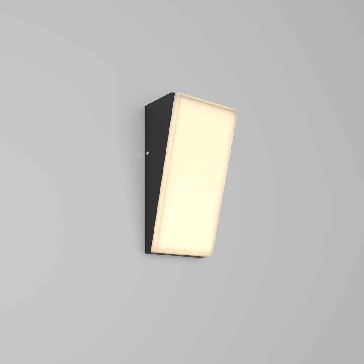 The Brick Outdoor LED Wall Light - Graphite (O436WL-L10GF3K1) features a sleek rectangular black fixture with a slanted illuminated front panel, emitting soft warm LED light. Its sophisticated graphite finish elegantly complements the plain light gray background.