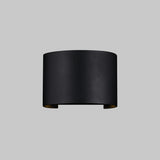 The Fulton Outdoor LED Oval Wall Light - Black features a minimalist, cylindrical design with an open top and bottom, made from corrosion-resistant aluminum, and mounted on a plain gray background.