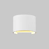 The Fulton Outdoor LED Oval Wall Light in white, made from corrosion-resistant aluminum, is wall-mounted and features a cylindrical design emitting a soft yellow glow from its open bottom against a plain gray background.