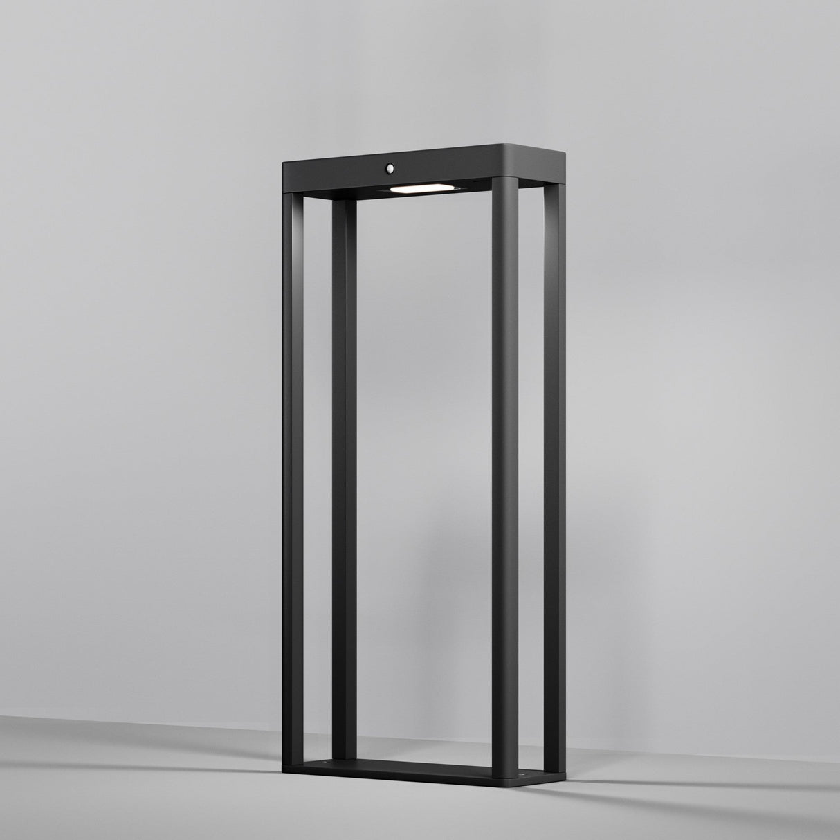 A modern, sleek graphite standing lamp with an open rectangular design sits against a plain gray background. The Pir LED Pedestal Light with Motion Sensor at the top softly illuminates the interior with a stylish glow.
