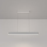 The Step LED Linear Suspension Light 4000K 23W - White showcases minimalist design with a sleek metal bar and energy-efficient lighting. Suspended by thin wires, it casts a warm glow in modern spaces, effortlessly blending style and functionality.