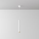 The Focus LED Pendant Light 3000K - White showcases a minimalist cylindrical design with a sleek white finish, elegantly suspended from a white ceiling against a light-colored wall.