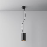 The Efir LED Pendant Light 15W in black hangs from a white ceiling, showcasing two thin, slightly curved wires that elegantly connect the energy-efficient fixture to the mount against a plain gray wall.