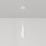 The Nevill Conical Pendant Light - White, with its minimalist cone-shaped shade, hangs elegantly from the ceiling, casting a gentle downward glow against a white backdrop when illuminated.