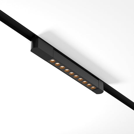 The Points Rot LED Swivel Linear Track Light, a sleek black fixture for single-phase track unity, features nine small circular LED bulbs that emit a warm 3000K glow. Its mounted on a smooth white ceiling, offering high color rendering and perfect illumination.