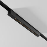 The Points Rot LED Swivel Linear Track Light emits a 22W warm 3000K glow, featuring a minimalist, modern design with multiple small lights on a black fixture mounted on a white ceiling.