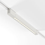 The Points Rot LED Swivel Linear Track Light is mounted on a single-phase track and features evenly spaced circular lights. Emitting a 3000K white glow with high CRI and a 22W output, its minimalist design and white finish seamlessly blend with the ceiling.