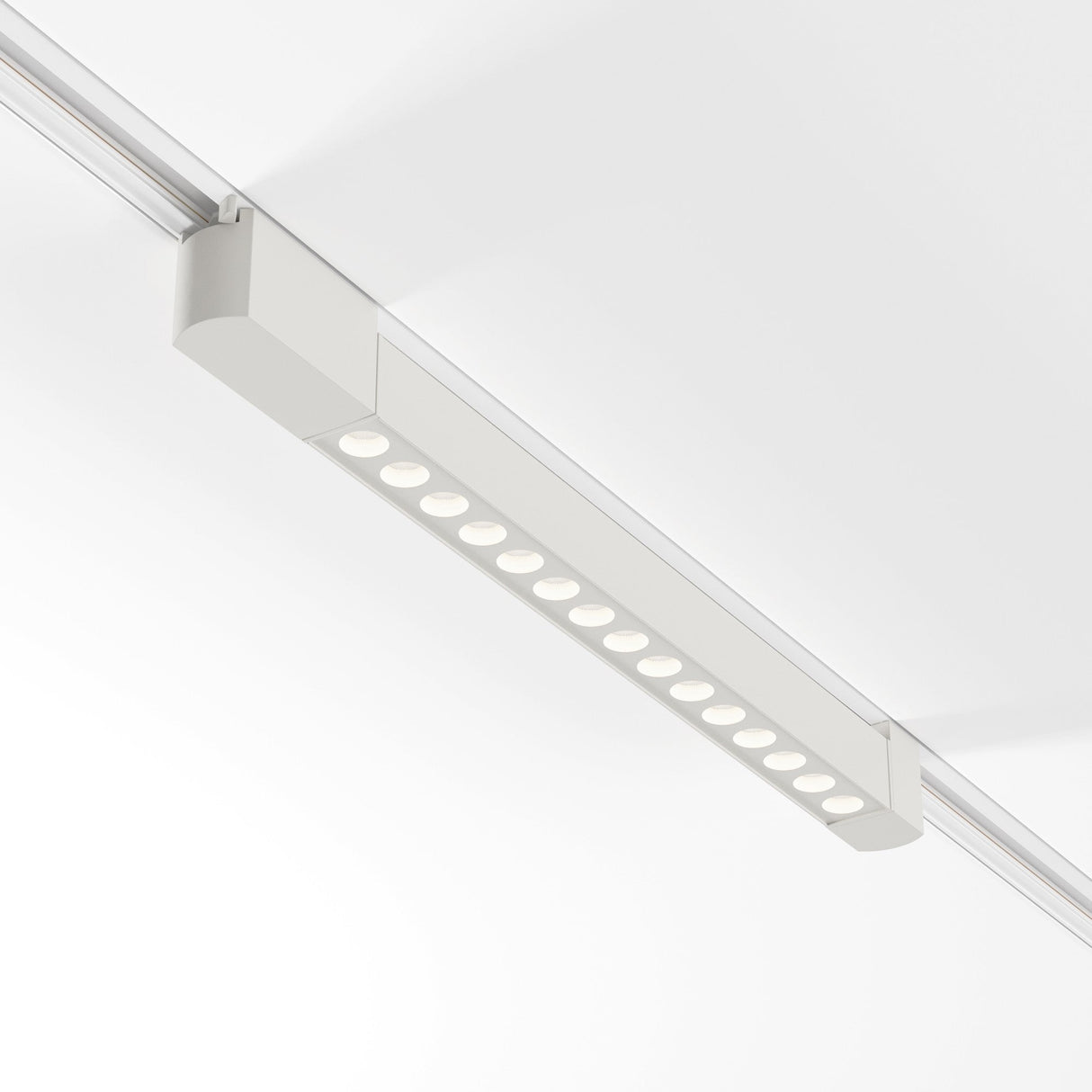 A Points Rot LED Swivel Linear Track Light, 22W 4000K, featuring a modern rectangular design and circular LEDs, is mounted on a white ceiling for perfect ambiance on the Single Phase Track Unity.