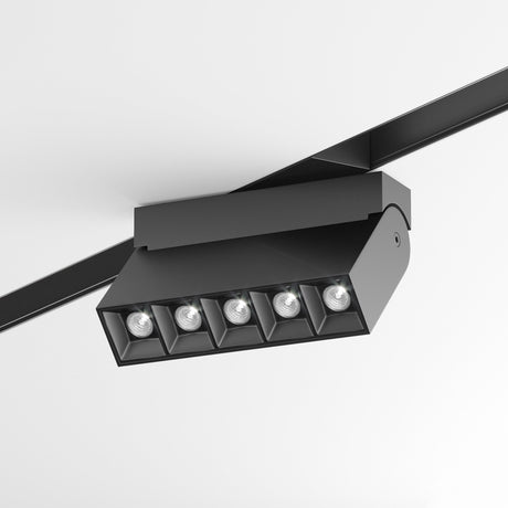 The Points Rot Adjustable LED Magnetic S35 Linear Track Light in black features five square LED bulbs on an adjustable track, offering energy-efficient lighting with flexibility and a sleek contrast against white ceilings.